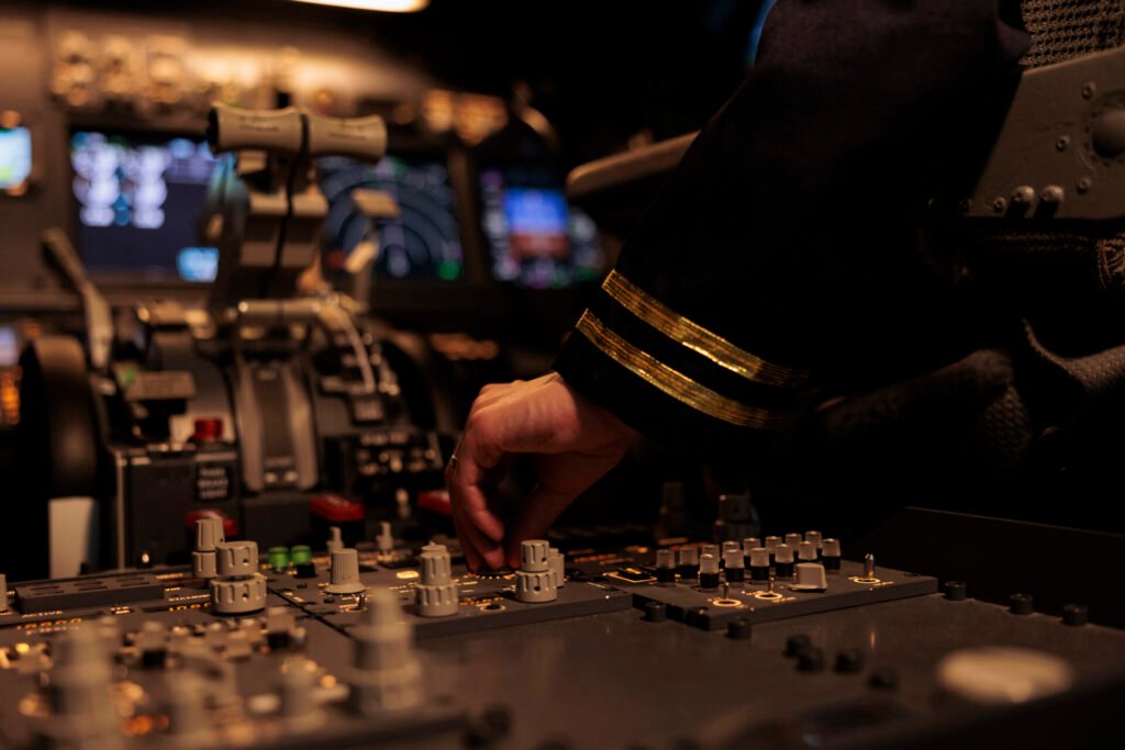 Female Copilot Switching Control Panel Buttons Dashboard Command Using Radar Compass Windscreen Cockpit Cabin Airliner Flying Plane Jet With Travel Navigation Close Up.jpg